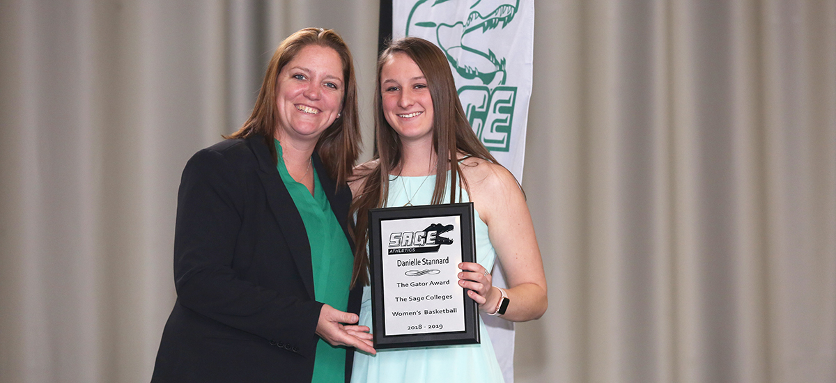 Head Women's Basketball Coach Allison Coleman awards Gator of the Year honors to Danielle Stannard