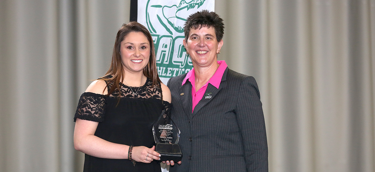 Samantha Trimblett receives her award from Director of Athletics, Sandy Augstein-Collins