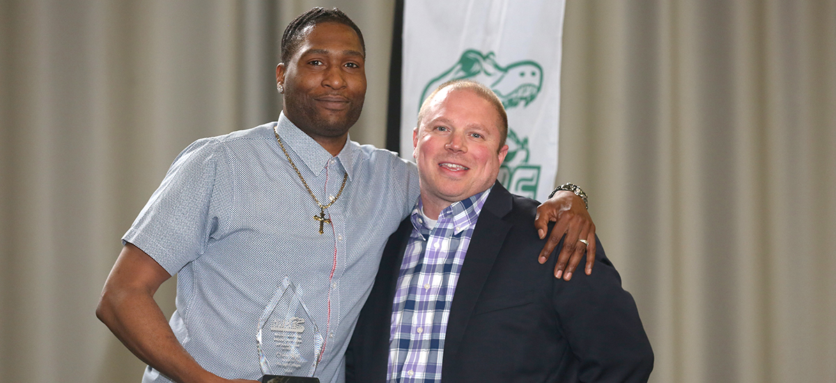 Chris Kidd is presented with Male Athlete of the Year status from Head Men's Basketball Coach Brian Barnes