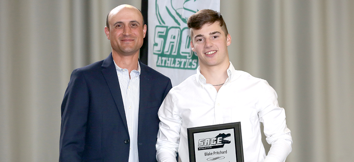 Head men's golf coach Kevin Cain presents Blake Pritchard with Gator of the Year status in golf