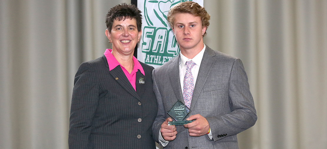 Director of Athletics Sandy Augstein-Collins awards DJ Baraniuk, 2018-2019 Sage Male Rookie of the Year Honors.