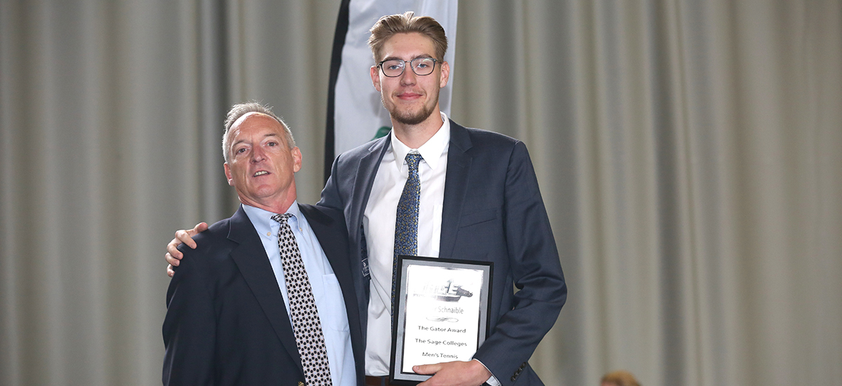 Head men's tennis coach Tom Fashouer presents Gator of the Year award to Tyler Schnaible