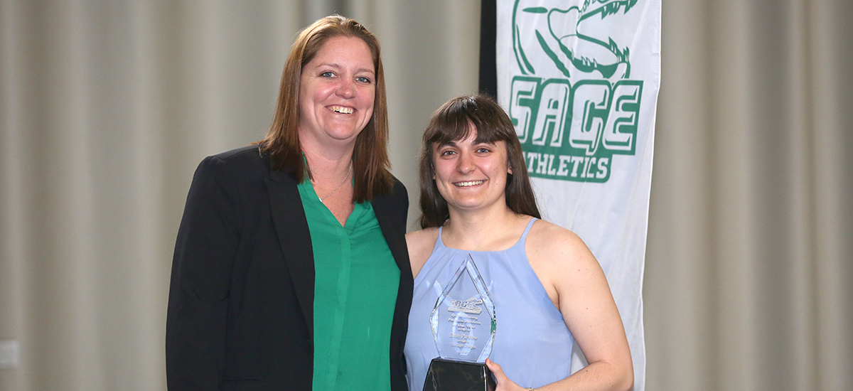 Head Women's Basketball Coach Allison Coleman presents Emily Parslow with her award.